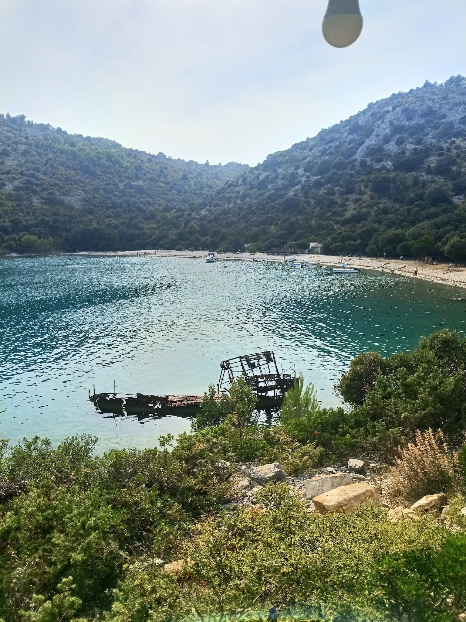 A sheltered bay beneath wooded hills