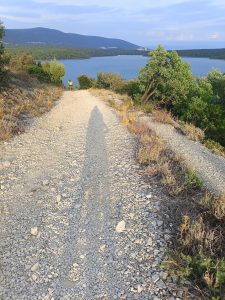 A gravel path leading downhill towards the sea
