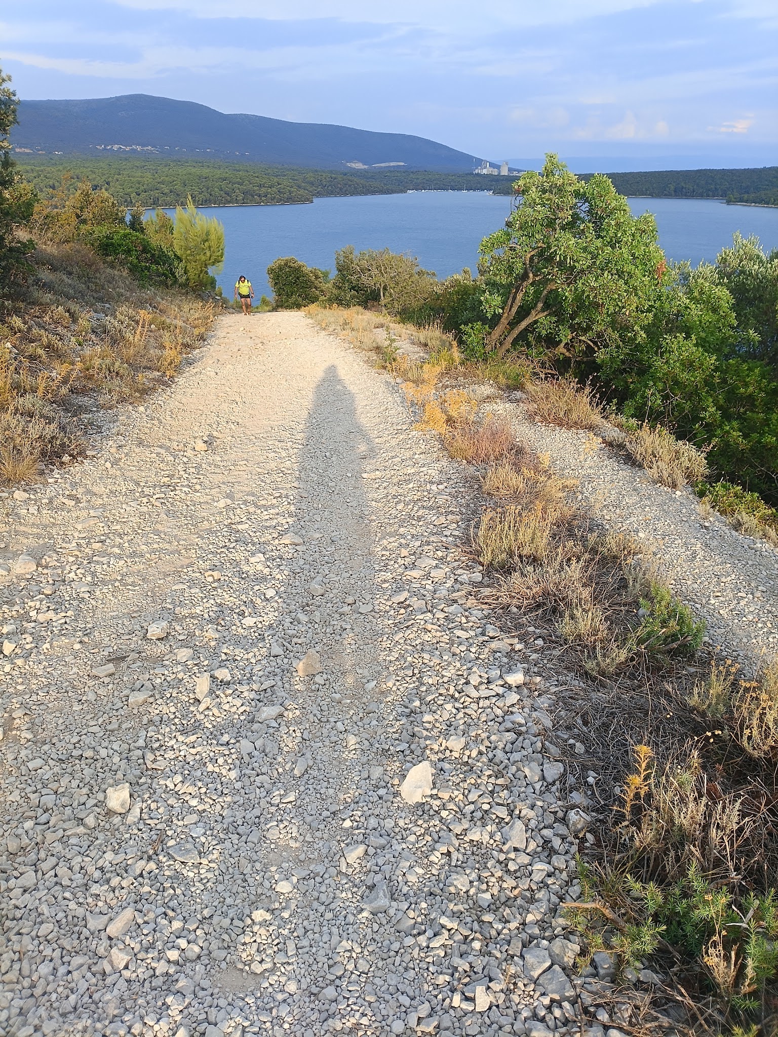 A gravel path leading downhill towards the sea